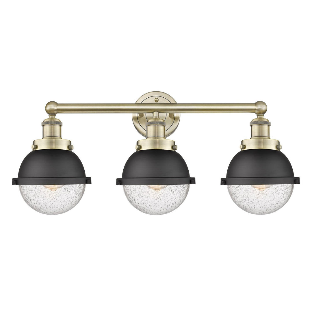 Innovations Downtown Urban 616-3W-AB-HFS-64-BK Bath Vanity Light 26 in. wide - Antique Brass
